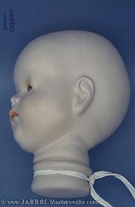Original bind-in doll head cast in liquid wood.